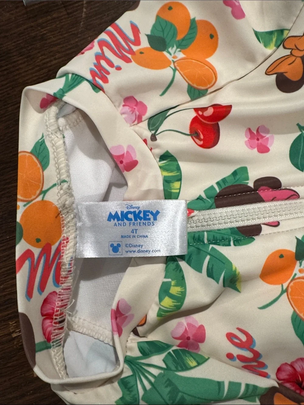 NWOT Kids Disney Cream One-Piece Rash Guard with Multicolor Fruit & Floral Print